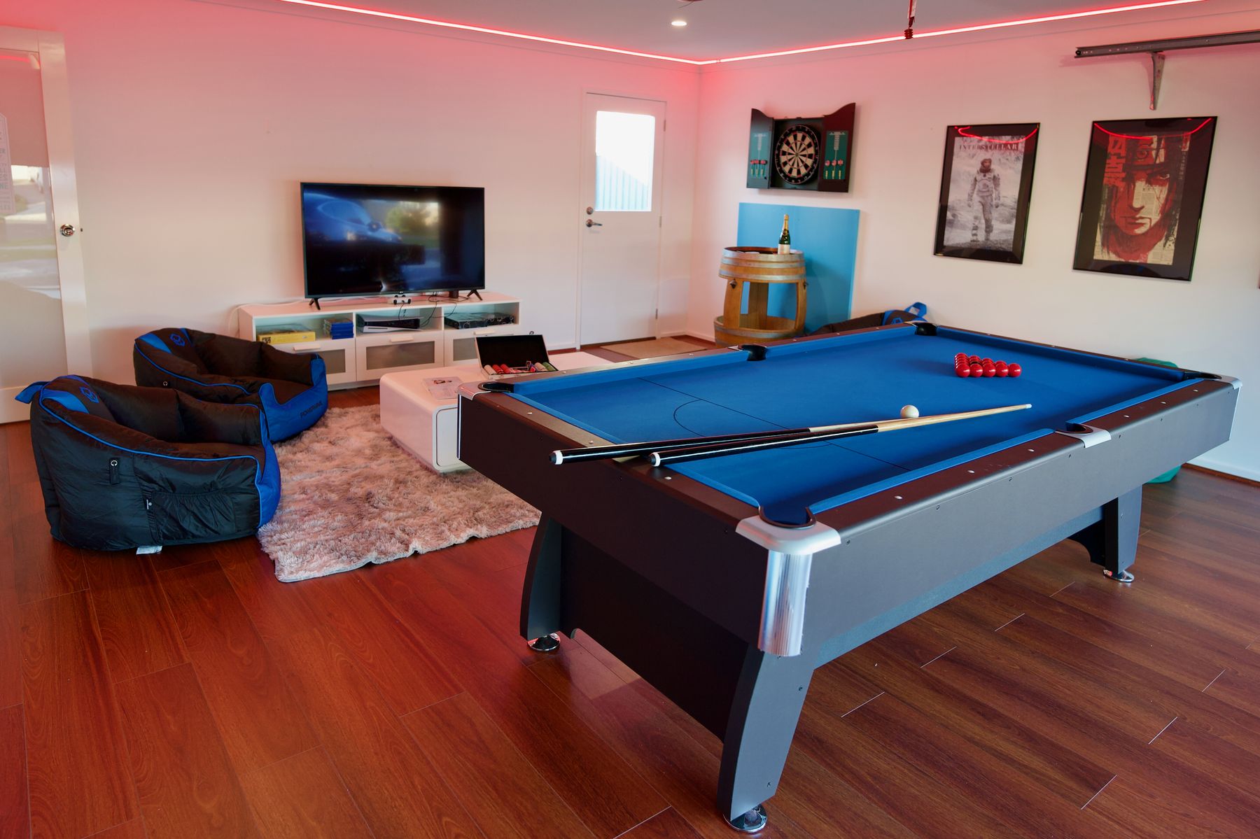 Games room with pool table and lounge seating